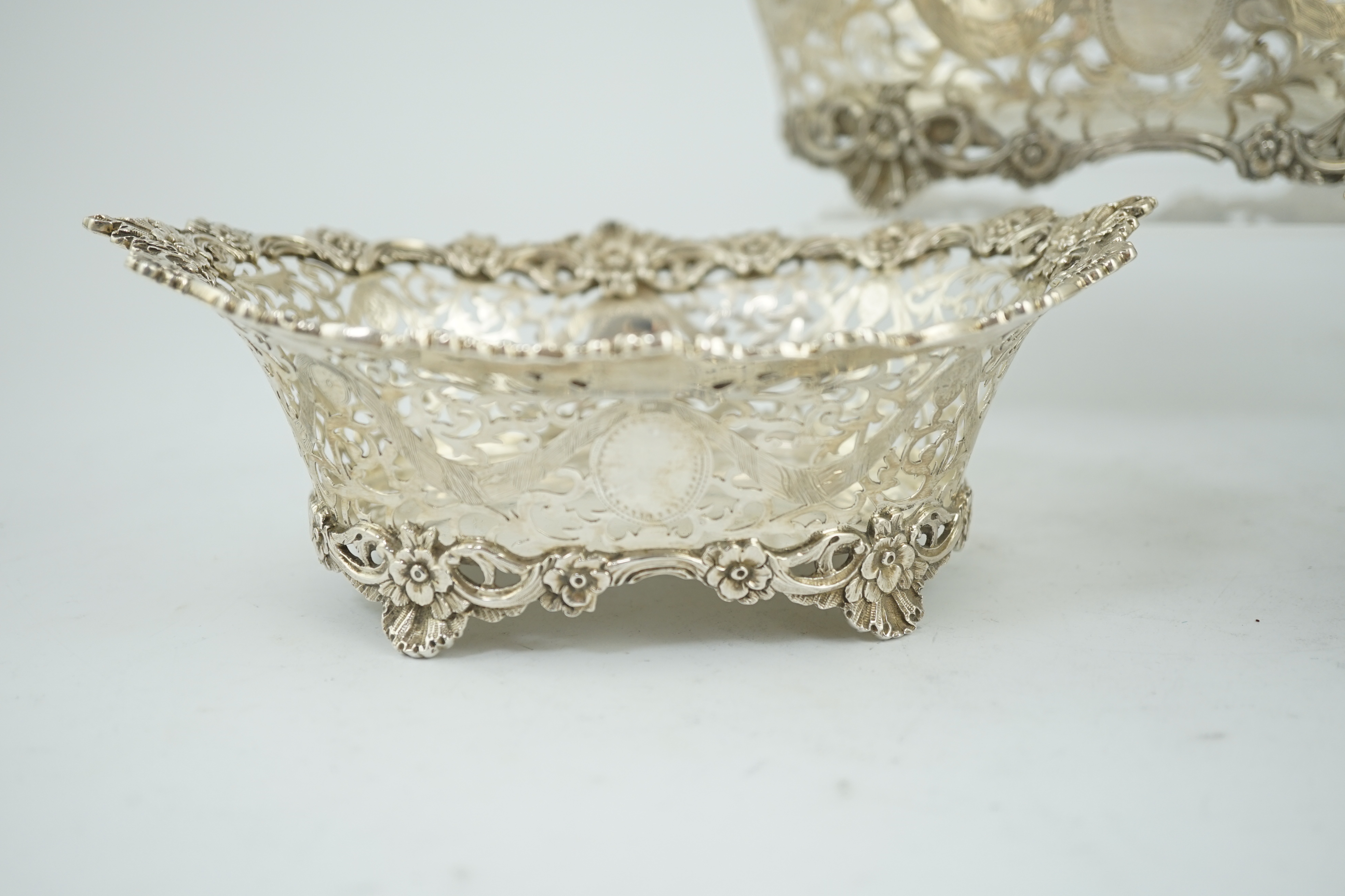 A graduated suite of three George V pierced silver oval bowls, by Charles Stuart Harris & Sons